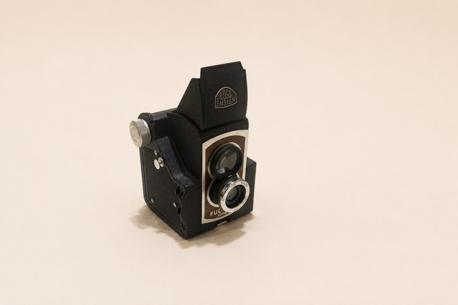 Ensign Ful-Vue Super pseudo-TLR camera with large brilliant viewfinder above taking lens, collapsible pressed-steel hood, and cast alloy body