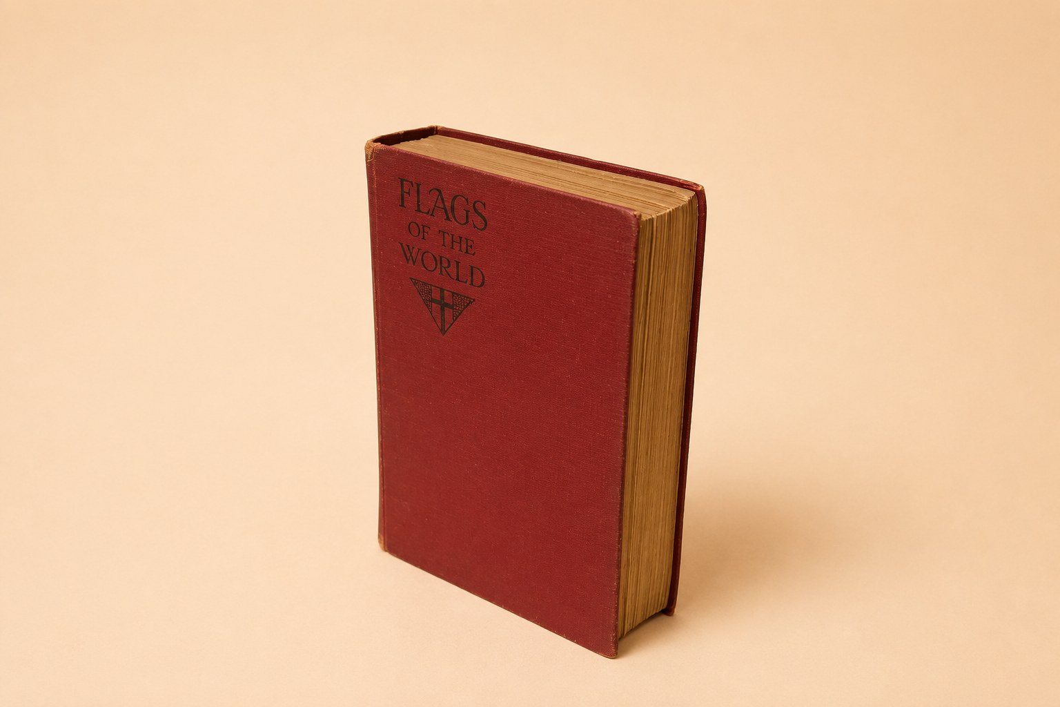 Red cloth-bound 1928 book 'Flags of the World, Past and Present' by W. J. Gordon, published by Frederick Warne; shown with its colour frontispiece of Nelson's Trafalgar signal in code flags and a front flyleaf signed in ink 'Ernest E. Ausden, March 1929'.